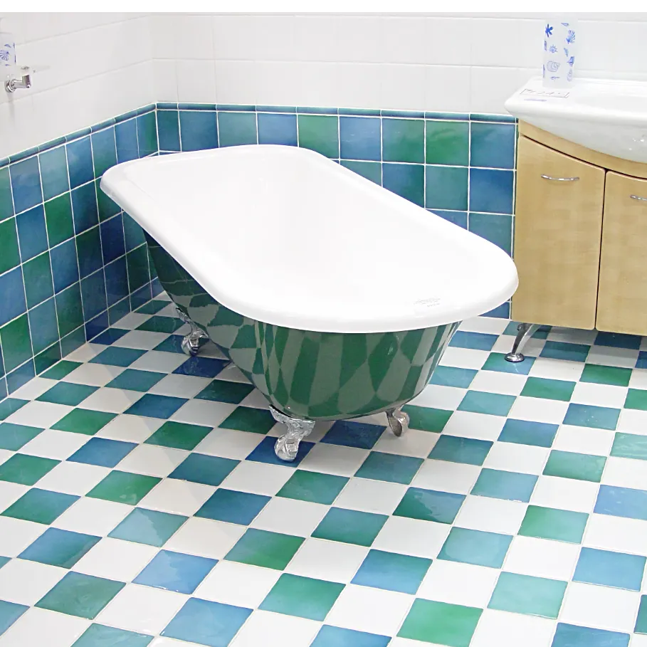 Freshly refinished stand alone bathtub on bright teal and blue tiles